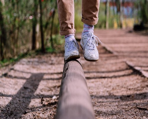 Person wearing comfortable shoes walking on cobblestone